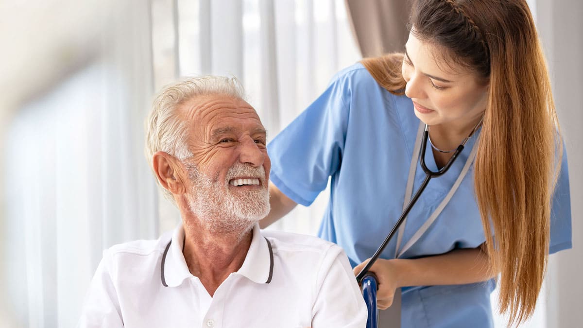 Man being cared for by a nurse at home.