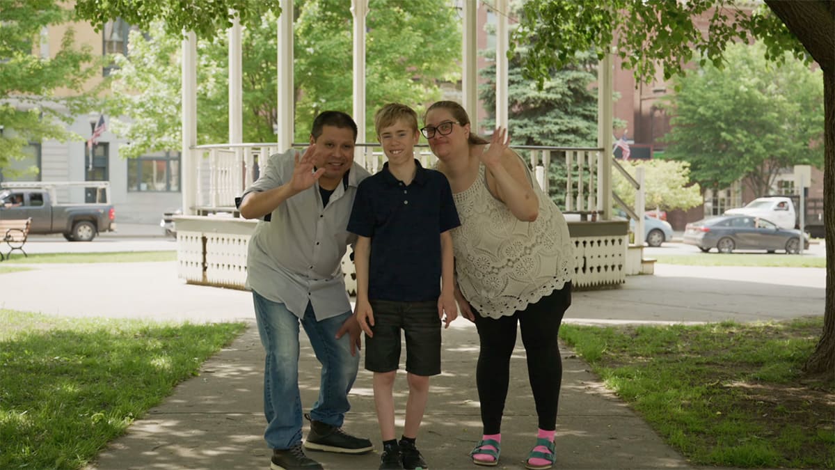 Keegan with his mom and dad in the park